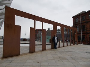 My sister in front of the cut metal "Titanic" sign in front of the museum.